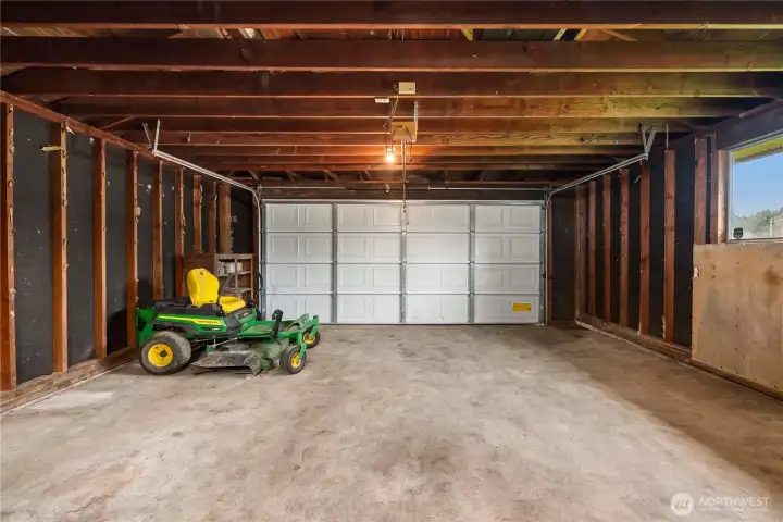 Oversized 2-car garage has plenty of room for cars and workspace. Riding Mower is negotiable!