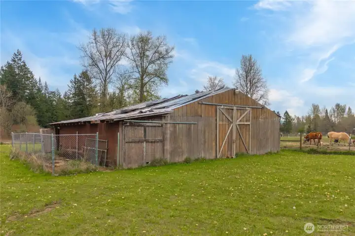 Barn needs new roofing, but is in solid condition. It was home to many animals over the years and is ready for new ones. The neighbor has horses!