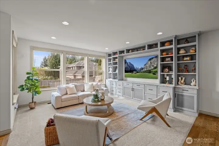 The great room space features floor to ceiling custom designed and built cabinetry.
