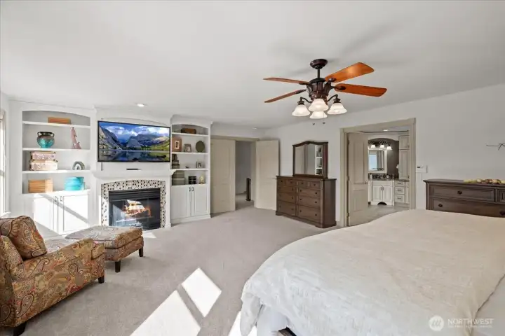 Double door entry to the stunning primary suite - you'll find the dedicated sitting area and fireplace as shown in the photo.