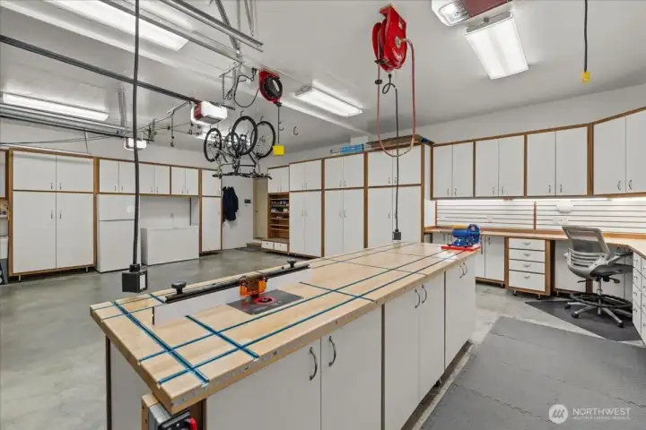 The 3 car 800 sq ft garage is outfitted with storage galore and amenities a hobbyist would love.