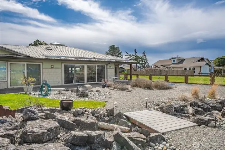 Gorgeous stone landscape features have been carefully planned and positioned to provide beauty without sacrificing useable space for outdoor fun.
