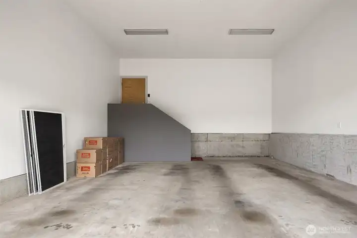 Large and tall garage for cars, boat, bikes, kayaks.