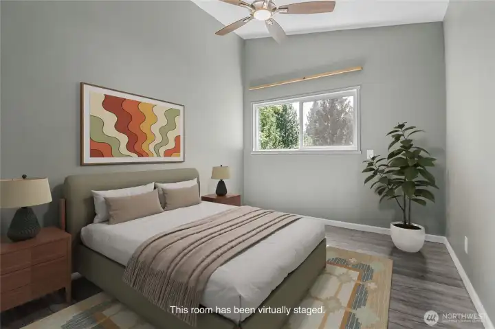 One of five bedrooms in the home; this room features a lovely vaulted ceiling and LVP flooring. That flooring makes this a natural spot for an office, craft space, or workout/yoga room.