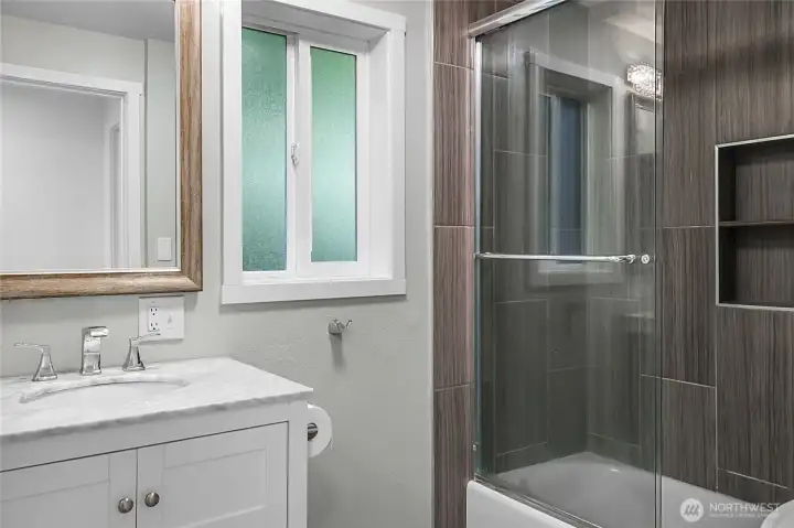 This remodeled bathroom serves the three bedrooms on this level ... but not the primary bedroom, which has its own private bathroom.