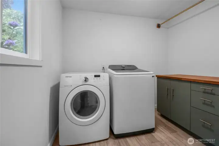 A laundry room with storage and a hanging rack? Yes!