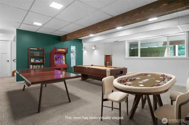 The large room on the lower level is perfect for hosting game night! Or turn it into your dream home media space. Door to the left leads to a large storage area.
