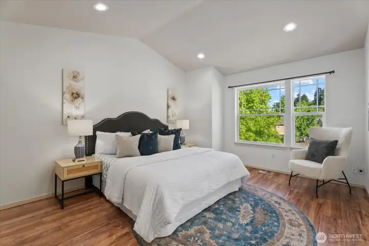 Primary bedroom with vaulted ceiling