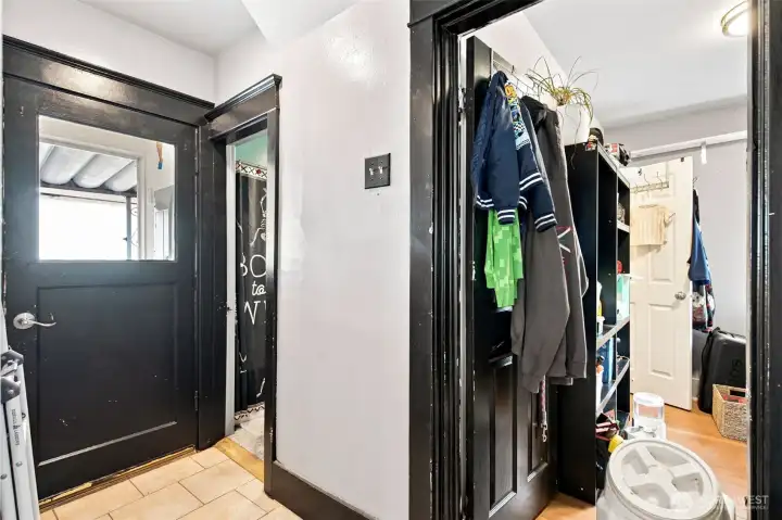 Hallway leading to the bathroom and back patio access
