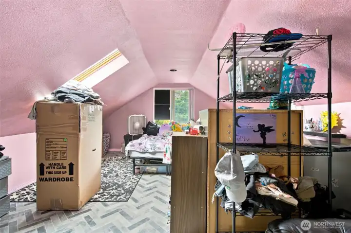 Bright loft bedroom featuring a skylight and peek-a-boo Sound views
