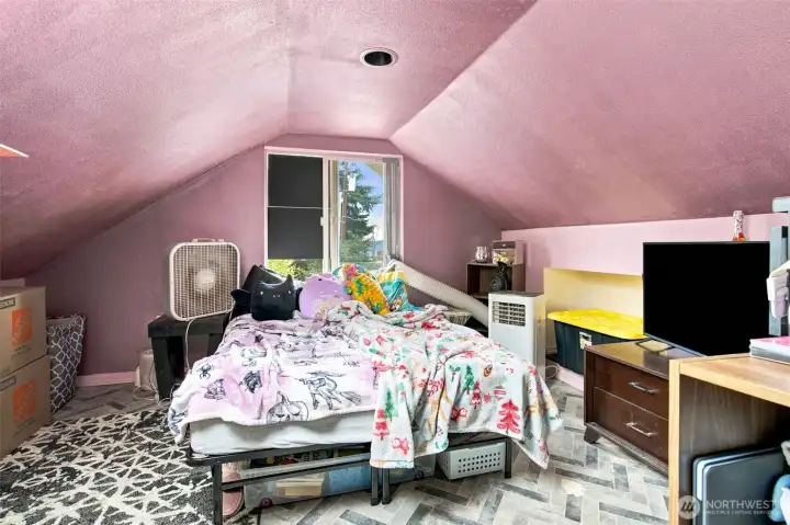 Bright loft bedroom featuring a skylight and peek-a-boo Sound views