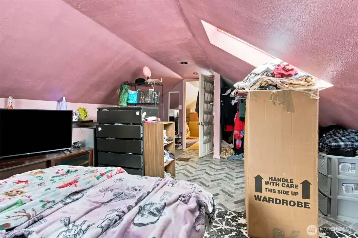 Bright loft bedroom featuring a skylight and peek-a-boo Sound views