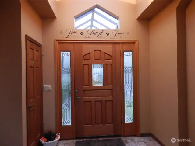 "Live well, Laugh often, Love much"  Standing inside your entry door with vaulted ceiling and skylights makes the sun brighten your day.  There is a glass covered walkway from your garage into the house.