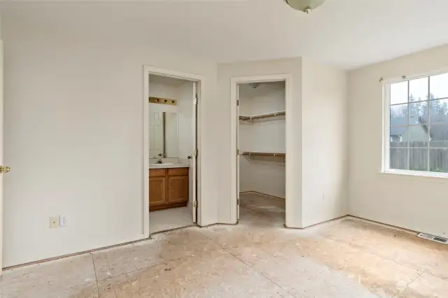 Primary bedroom with walk in closet and en suite bathroom.