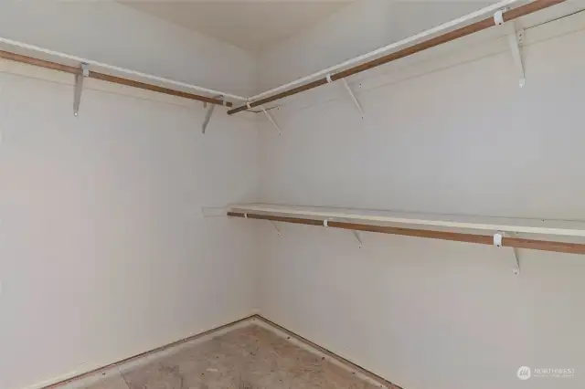 Walk in closet in primary bedroom.