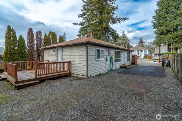 Long driveway into back of property. Wood deck attached to the back of the home. Fenced on three sides of the property.