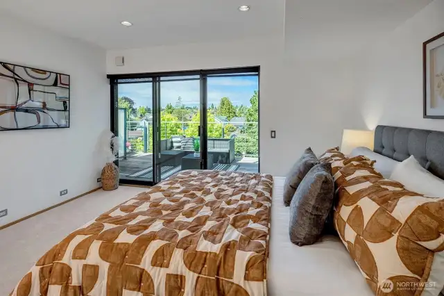 The expansive primary bedroom offers sliders to a private, vast deck with a territorial view, creating an ideal oasis of tranquility and an indoor/outdoor living experience.