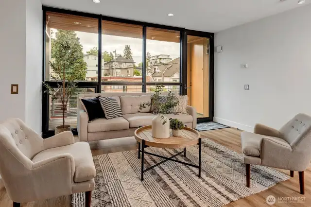 Enjoy a majestic open-concept living area with floor-to-ceiling windows that flood the space with natural light, complemented by new LVP flooring with radiant heating throughout the living area.