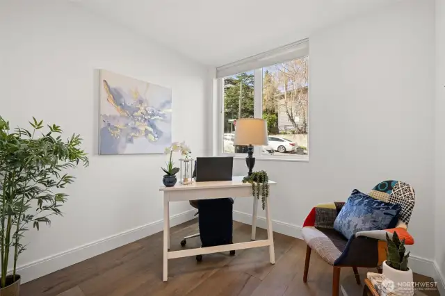 Lower Level- Office, den or extra bedroom (does not have closet, but could be a third bedroom) with beautiful engineered hardwood floors, lots of natural light, beautiful flower garden right outside window; perfect for work from home or relaxing while gaming