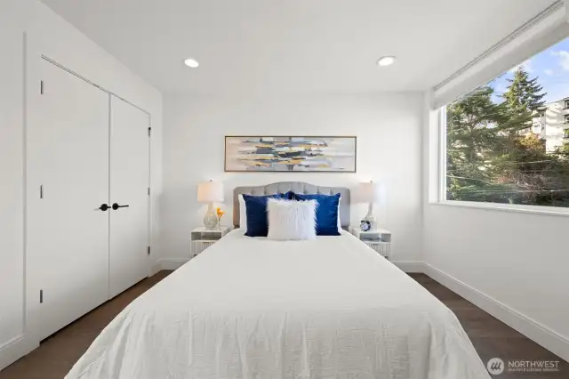 Second Floor Primary Bedroom with gorgeous glass shower ensuite. Beautiful engineered hardwood floors, lots of natural light from windows, and large closet