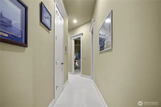 Hallway leading to other bedrooms, den/office, and full bathroom