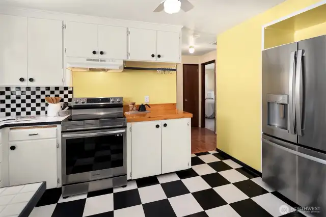 No more digging through cabinets for that frying pan—this kitchen comes with a handy pot rack for easy access and storage, plus a new refrigerator to keep things cool. Perfect for keeping your cooking essentials within reach and adding a little rustic charm.