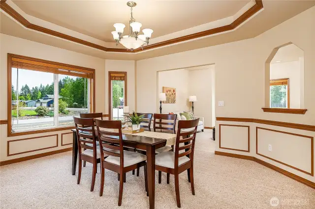 Spacious Formal Dining Room looking towards the front Living Room. Note the custom wood coffered ceiling and chair rail.
