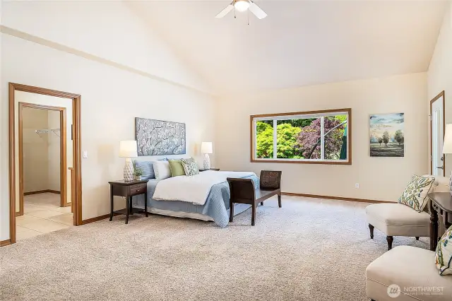Spacious primary suite with serene views of the backyard and direct deck access. Walk-in closet and en-suite bath just steps away—your private retreat awaits.
