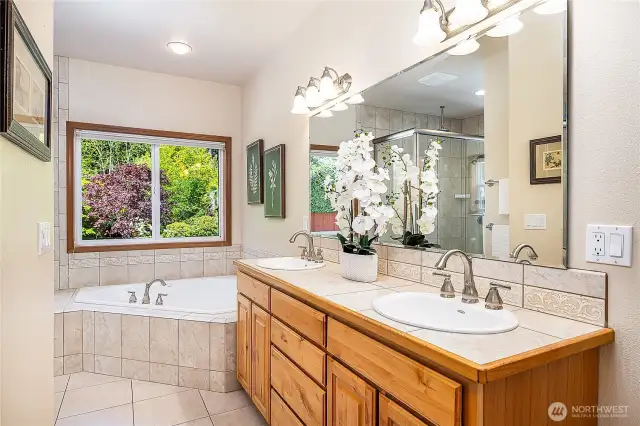 Primary bathroom with double vanities, a jetted soaking tub, and a walk-in shower—designed to create a relaxing, spa-like retreat right at home.