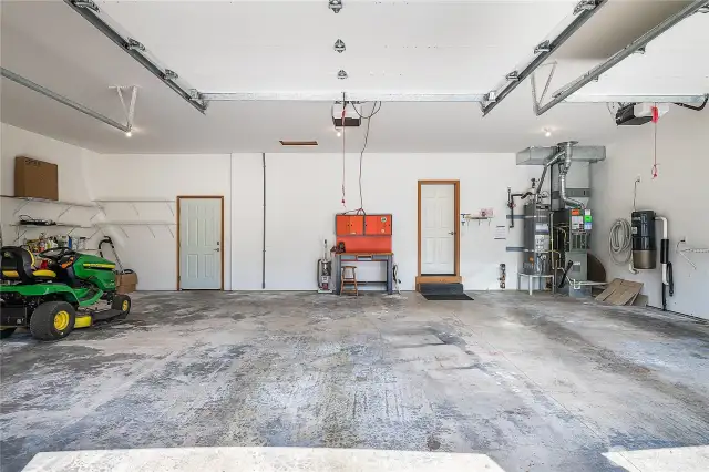 Spacious & clean 3-car garage. Note the built-in vacuum on the right.