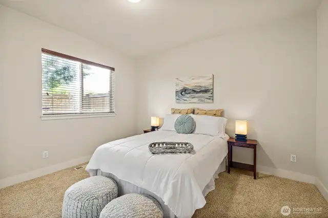 Main level bedroom is perfect as a primary or junior suite, with an adjacent full bath.