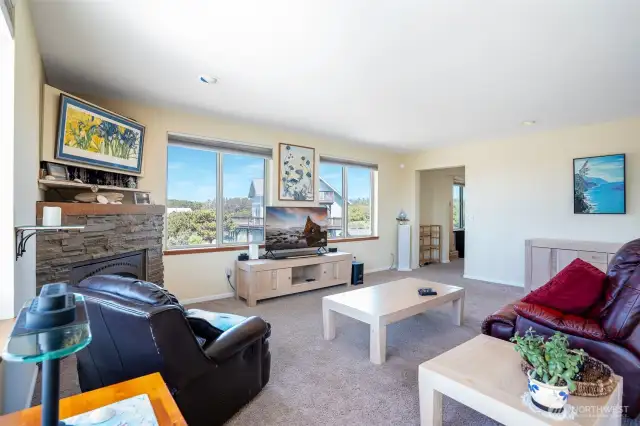 View of living space leading into office & primary suite.