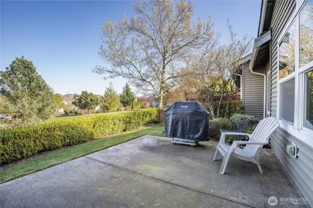 Partially-fenced yard with large patio