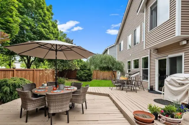 Spacious fenced backyard with expansive multi-level deck.
