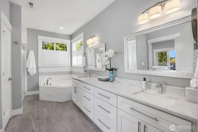 Primary Bath with separate shower, tub, two sinks and adjacent walk-in closet.