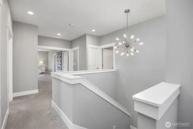 The Elevator to this 3rd level is located to the immediate right, the stairwell is straight ahead and the door to the right leads to a full bath serving the 2nd and 3rd bedrooms on this level.  Wide French Doors beckon you to the Primary Suite also.