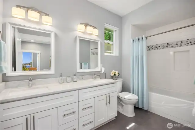 Double sinks and a tiled bath serves the 2nd and 3rd bedrooms.