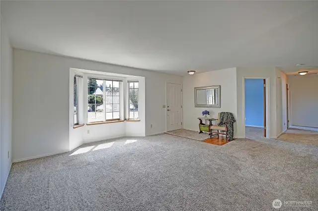 Great living room by the front door with newer carpet and lots of light.
