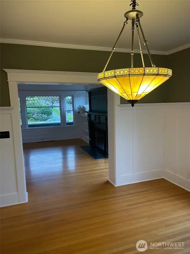 Apt A - Large dining room continues with hardwood floors and an exquisite chandelier.
