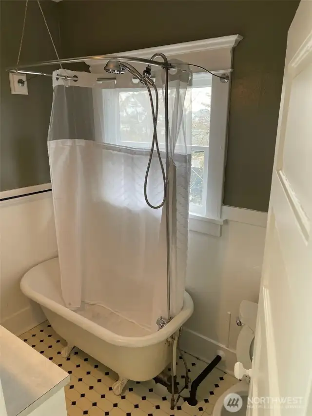 Apt B - Nostalgic full bath boasts of a vintage claw and ball foot tub/shower.