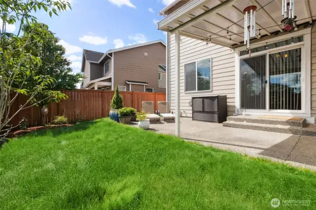 Enjoy the fully fenced yard with patio and lush lawn and mature trees!
