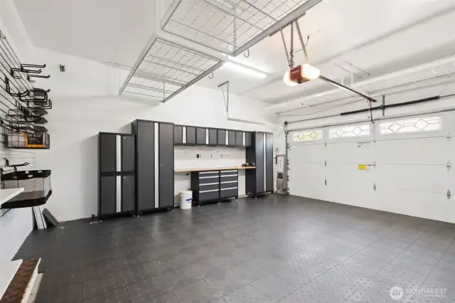 Amazing garage! From the interlocking vinyl flooring to the cabinets to the installed organizer systems--everything runs with the house sale!!