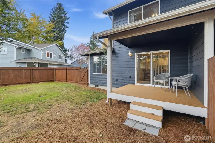 Fully fenced large backyard with cozy covered back deck.