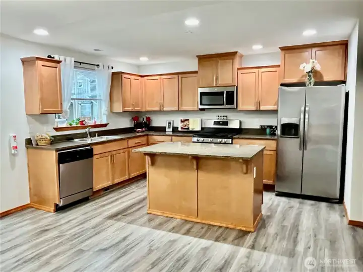 Modern Kitchen with granite countertops, stainless steel appliances.