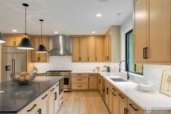 WOW! This kitchen is both beautiful and practical. Wide aisles, high end appliances, tasteful fixtures and walk in pantry.