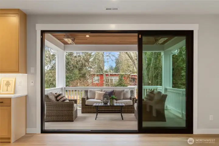 A wall of glass leads to the covered and heated deck.