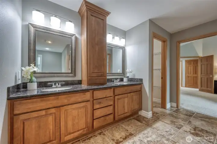 Beautiful primary bath double vanity with view of one of the 2 walk-in closets.