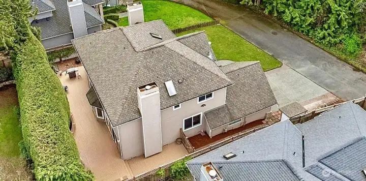 Private backyard oasis featuring an expansive wraparound deck and mature trees that create exceptional privacy in this peaceful Sammamish neighborhood.