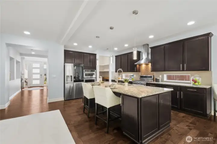 Refined chef’s kitchen showcasing a generous central island ideal for both prep and entertaining.