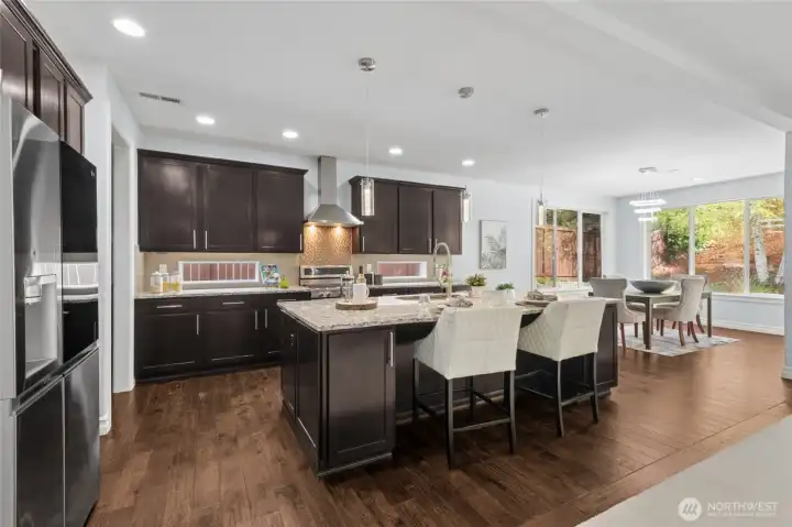 The well-designed kitchen includes slab countertops and top-tier stainless steel appliances, blending style and function.